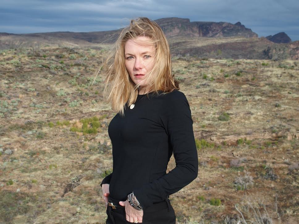 Poet Julie Bloemeke stands outdoors.