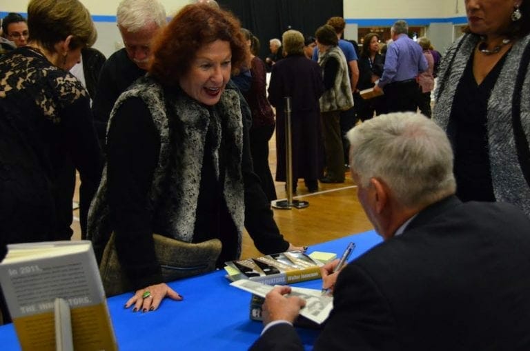 An author signs a book at the Marcus Jewish Community Center's annual book festival.