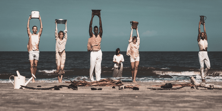 Dancers on a beach for the National Water Dance projects performance.
