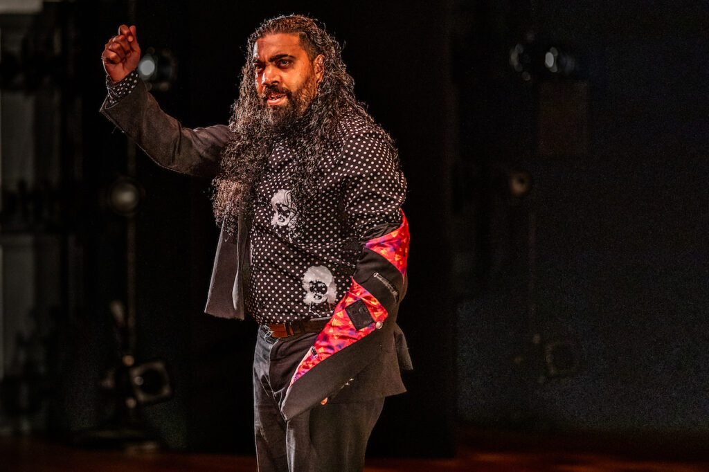 Dancer El Bocadillo drops a jacket sleeve, a timeless gesture in flamenco (Photo by Erik Voss)
