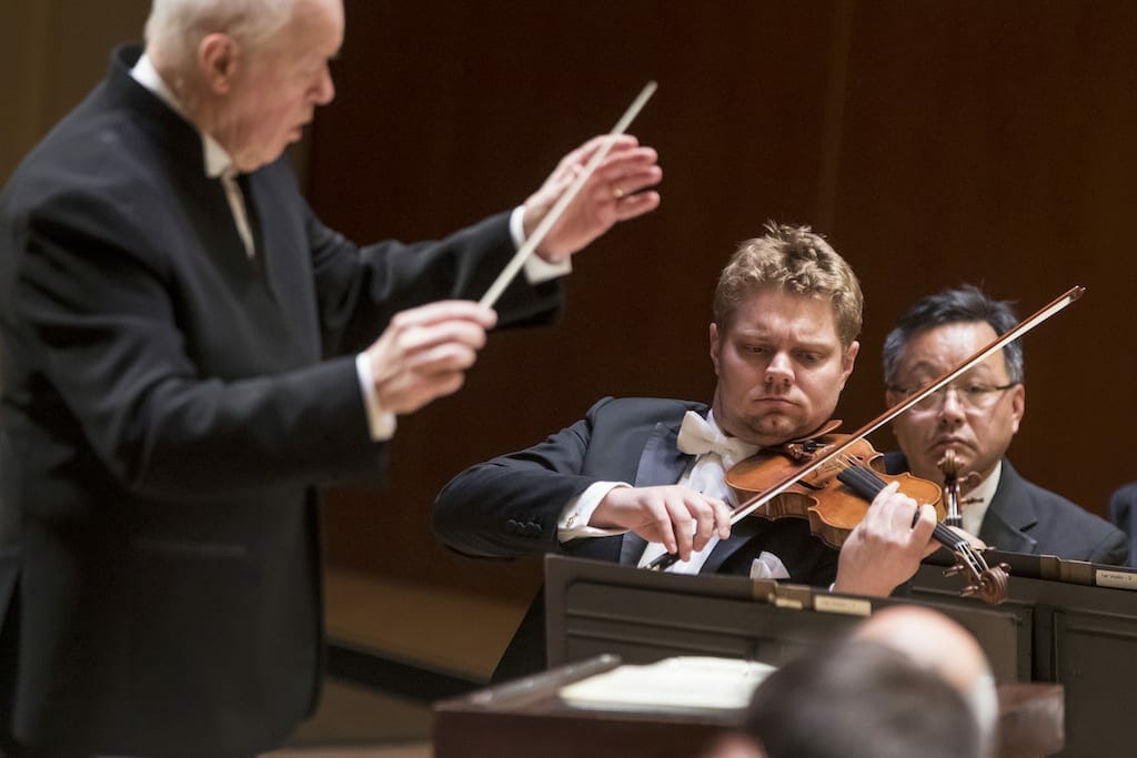 A guest conductor with violinist David Coucheron performing a solo.