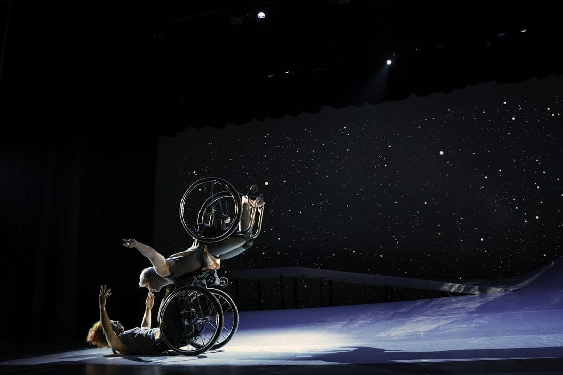 Two disabled dance artists from Kinetic Light perform on stage.