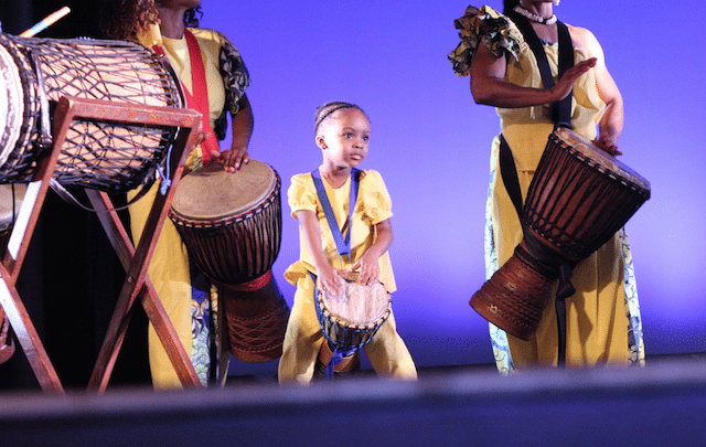 Nia Kelly, center, plays djembe with artists of Giwayen Mata.